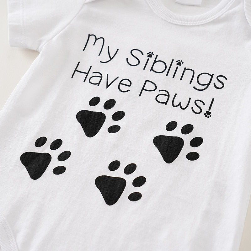 White t-shirt with black text 'My Siblings Have Paws!' and paw prints on a white background